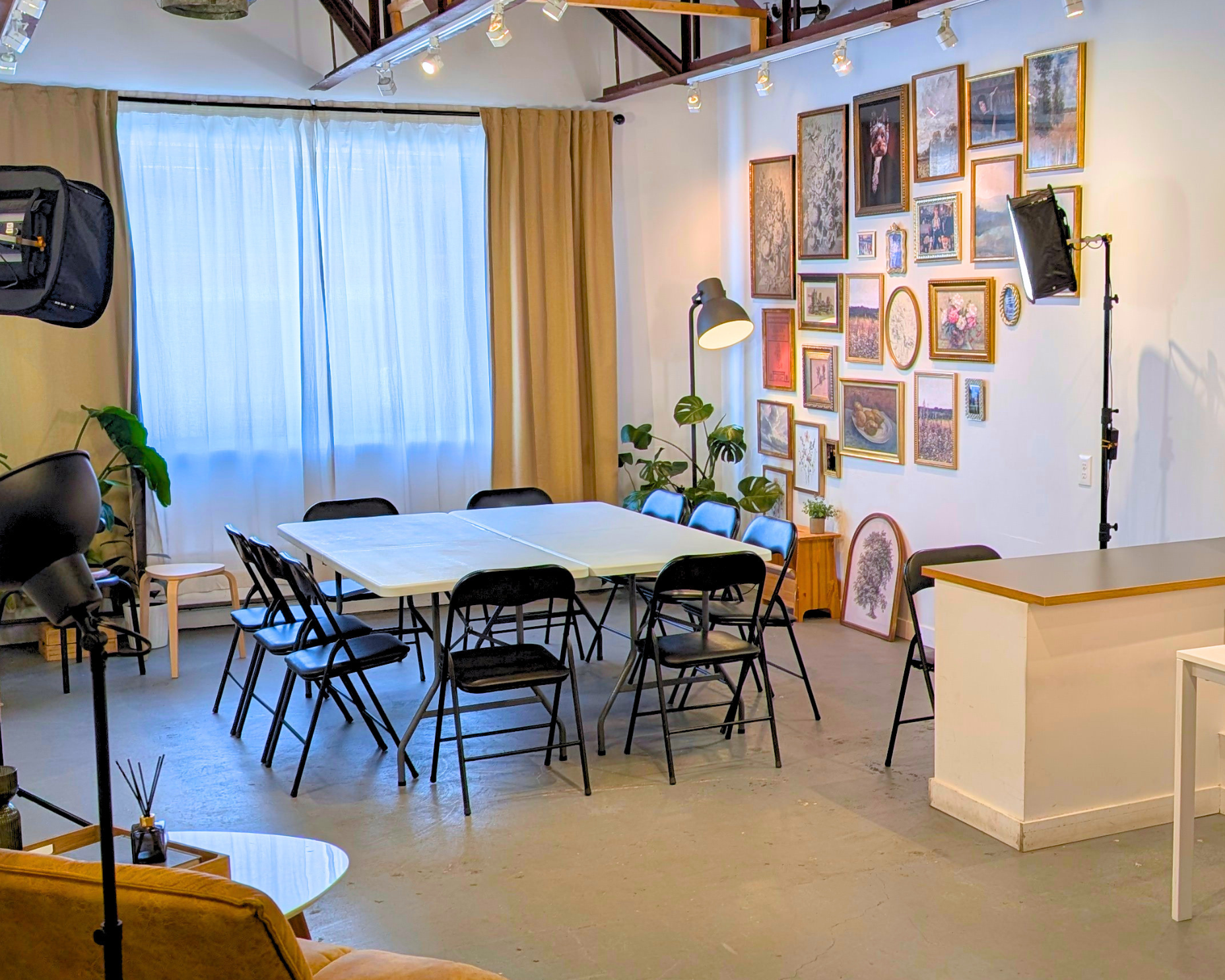 Folding tables arranged as a square with chairs and lighting for collaborative sessions